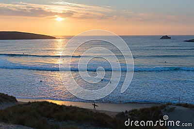 Cornwall sunset surfers surfing Crantock bay and beach North Cornwall England UK near Newquay Stock Photo