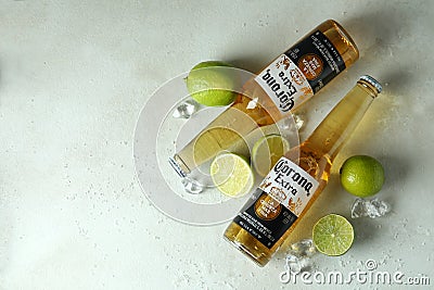 Corona Extra, limes, salt and ice on white textured background Editorial Stock Photo