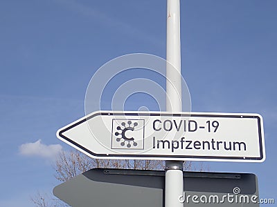 Corona: Signpost to a COVID-19 Vaccination Center in Germany Editorial Stock Photo