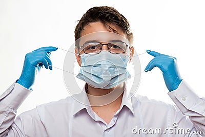 Corona virus covid-19 : Closeup with the face of a young doctor with glasses and wearing medical or surgical mask Stock Photo