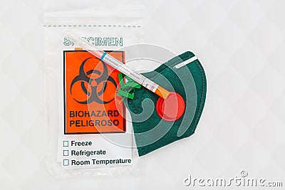 Corona virus Covid-19 respiratory sputum specimen swab test tube with gloves, mask and biohazard bag Stock Photo