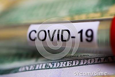 Corona virus covid-19 uncertain consequential costs concept symbol: macro closeup of isolated blood sample vial on 100 us dollar Stock Photo