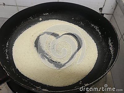 During corona virus pandemic quarantine i was trying to cook semolina and drawn this love symbol to show i love cooking in heart Stock Photo