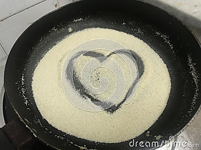 During corona virus pandemic quarantine i was trying to cook semolina and drawn this love symbol to show i love cooking in heart Stock Photo