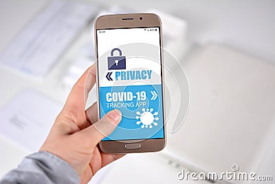 Corona Virus Tracking App privacy concerns concept with hand holding cell phone with application design showing choice Stock Photo