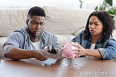 Coronacrisis Concept. Desperate African Couple Counting Last Money At Home Stock Photo