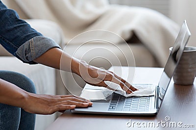 Coronavirus Cleaning Tips. Black Woman Sanitizing Laptop Keyboard With Antibacterial Wipes Stock Photo
