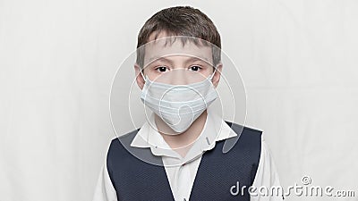 Coronavirus covid-19 epidemy outbreak healthcare concept of little boy in medical mask and school uniform Stock Photo