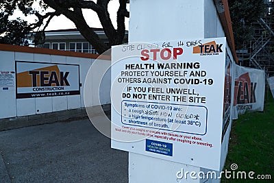 Coronavirus COVID-19 health warning sign outside a building site Editorial Stock Photo