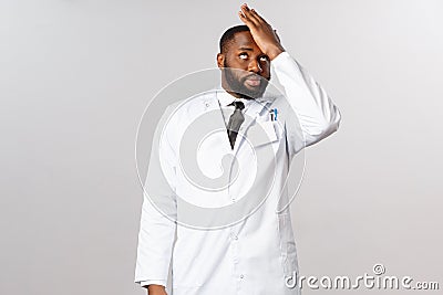 Coronavirus, and healthcare concept. Stupid people. Annoyed and bothered african-american doctor tired tell Stock Photo