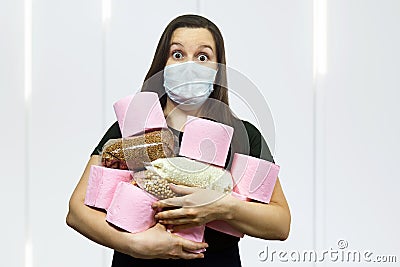 Coronavirus COVID-19 hysteria with toilet paper. Woman in a protective mask. Concept on the topic coronavirus, isolated Stock Photo