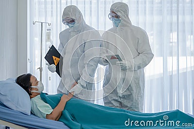 Coronavirus covid 19 treatment background of coronavirus covid 19 patient on bed with doctors in PPE coverall suit in hospital Stock Photo