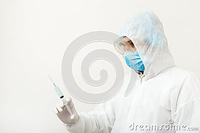 Coronavirus, covid-19 vaccine. Doctor scientist in protective medical suit, biological hazard, face mask holding vaccine in Stock Photo