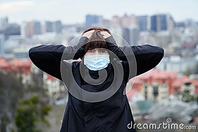 Coronavirus disease and world pollution panic: woman in medical mask on a city background Stock Photo