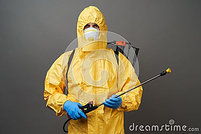 Coronavirus disinfection concept. Man in hazmat suit making disinfection Stock Photo