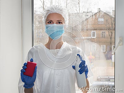 Coronavirus disinfection. People in making disinfection on windows. Doctor in rubber gloves disinfects windows Stock Photo