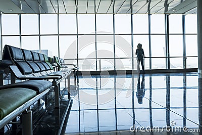 Coronavirus emergency worldwide for tourism and transport lockdown - standing lonely people at the airport with nobody traveling Stock Photo
