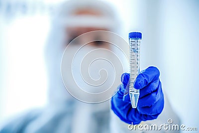 Coronavirus epidemic in the world, a nurse in a respiratory mask holds a test tube with sample Stock Photo