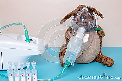 Coronavirus. Funny dog with a medical face mask or nebulizer for treatment of the respiratory tract further five ampoules with Stock Photo