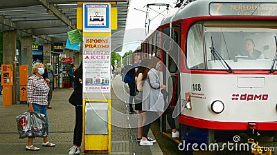 OLOMOUC, CZECH REPUBLIC, JUNE 22, 2020: Coronavirus mask face tram streetcar stop tram crowd people passengers they get Editorial Stock Photo