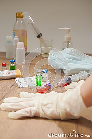 coronavirus outbreak, Virus and recovery concept, there are hands with gloves, vaccine bottles with red or green liquid, surgery Stock Photo