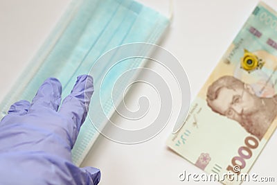 Coronavirus pandemic. Choise of taking money or medical mask for infection prevention. Problem of speculation Stock Photo