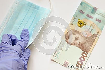 Coronavirus pandemic. Choise of taking money or medical mask for infection prevention. Problem of speculation Stock Photo