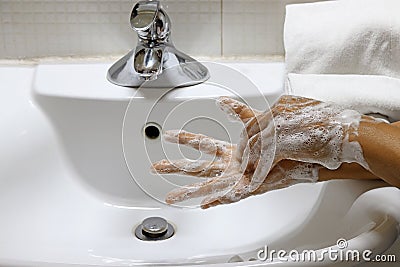 Coronavirus pandemic prevention wash hands with soap warm water Stock Photo