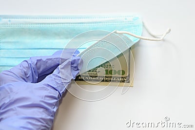 Coronavirus pandemic. Problem of speculation and jacking up of prices. Hand in blue glove, hospital morbidity Stock Photo