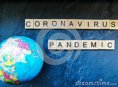 Coronavirus pandemic text with globe on blue background Stock Photo