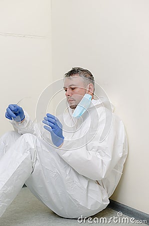 The coronavirus pandemic . A tired, exhausted doctor struggles with the coronavirus in a hospital clinic after a long Stock Photo