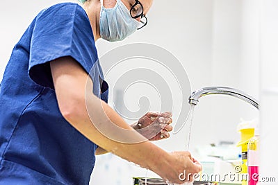 Coronavirus prevention. Nurse washing her hands after treat a patient with Covid-19 infection. Medical sanitizing Stock Photo