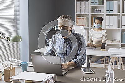 Coronavirus prevention and social distancing in the office Stock Photo