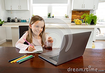 Coronavirus school closures and lockdown. Schoolgirl talking with teacher on a online class at home Stock Photo