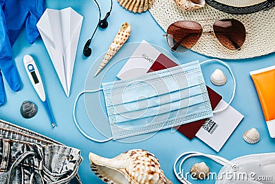 Coronavirus travel accessories on blue surface Stock Photo