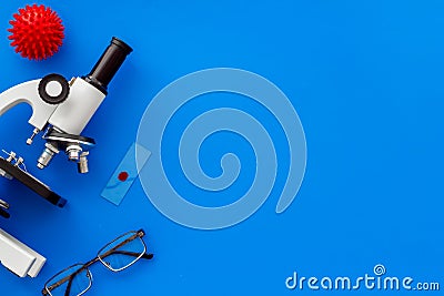 Coronavirus vaccine, research with microscope. Blue background top view copy space Stock Photo