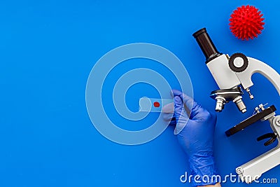 Coronavirus vaccine, research with microscope. Blue background top view copy space Stock Photo