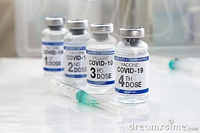 COVID-19 vaccine vials for vaccination labeled with 1st, 2nd, 3rd and 4th doses for booster shot against omicron variants Stock Photo