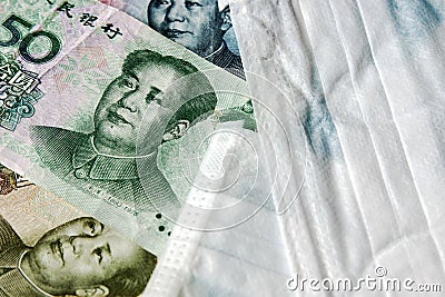 Coronavirus Wuhan illness concept. Chinese money and medical mask Stock Photo