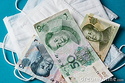 Coronavirus Wuhan illness concept. Chinese money and medical mask Stock Photo