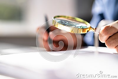 Corporate Auditor Using Magnifying Glass Stock Photo