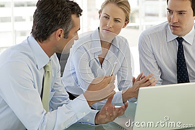 Corporate business teamwork - businessmen and woman working on laptop Stock Photo