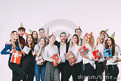 Corporate, celebration and holidays concept - happy team with gifts having fun birthday party. Stock Photo