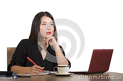 Corporate company portrait of young beautiful and busy Asian Korean businesswoman working at office computer desk concentrated in Stock Photo