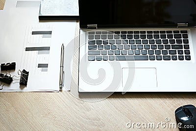 Corporate identity mock up on an desk with laptop and documentation with graphics. Stock Photo