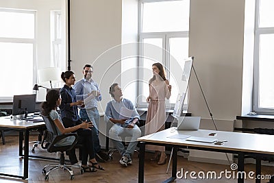 Corporate mentor woman teaching multiethnic students, interns Stock Photo