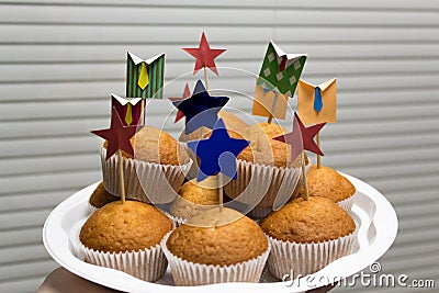 Corporate office muffins on a background of blinds. Stock Photo