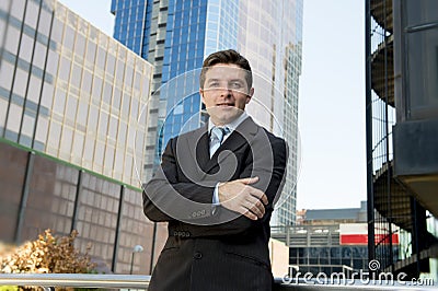 Corporate portrait attractive businessman standing outdoors urban office buildings Stock Photo