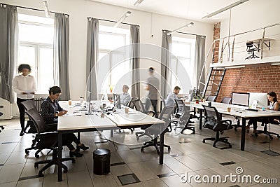 Corporate staff employees working together using computers at co Stock Photo