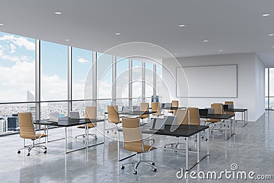 Corporate workplaces equipped by modern laptops in a modern panoramic office in New York City. Brown leather chairs and a black ta Stock Photo